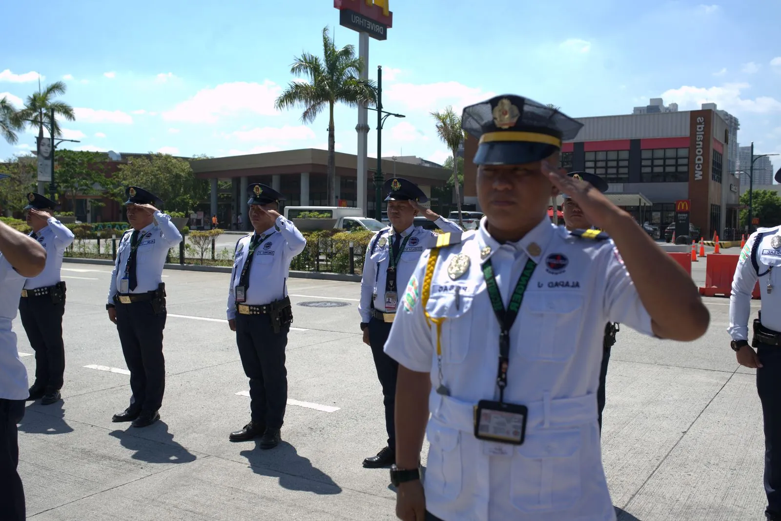 Pacific Ranger security officers saluting at a client site in Metro Manila.